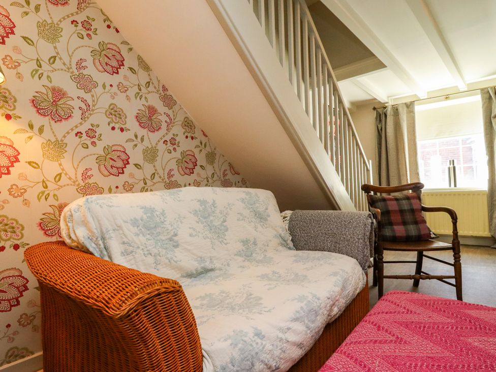 A living room with a sofa and armchair at Blue Cottage in Malton