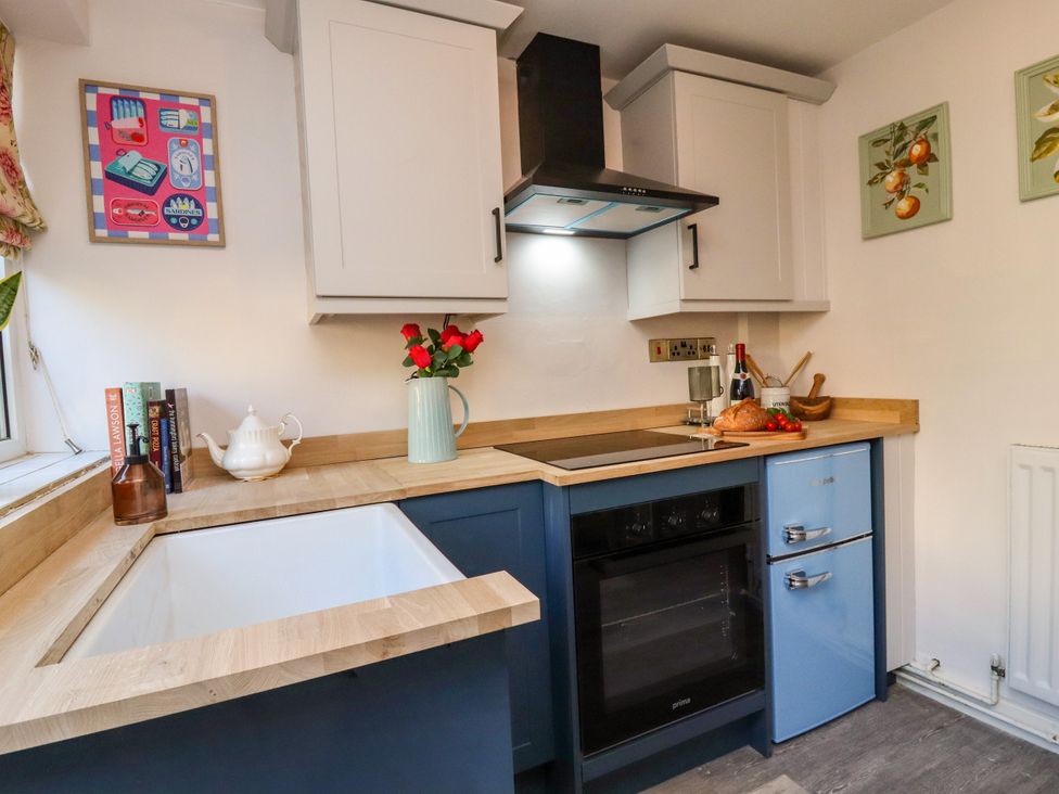 A kitchen with wooden countertop and appliances at Blue Cottage in Malton