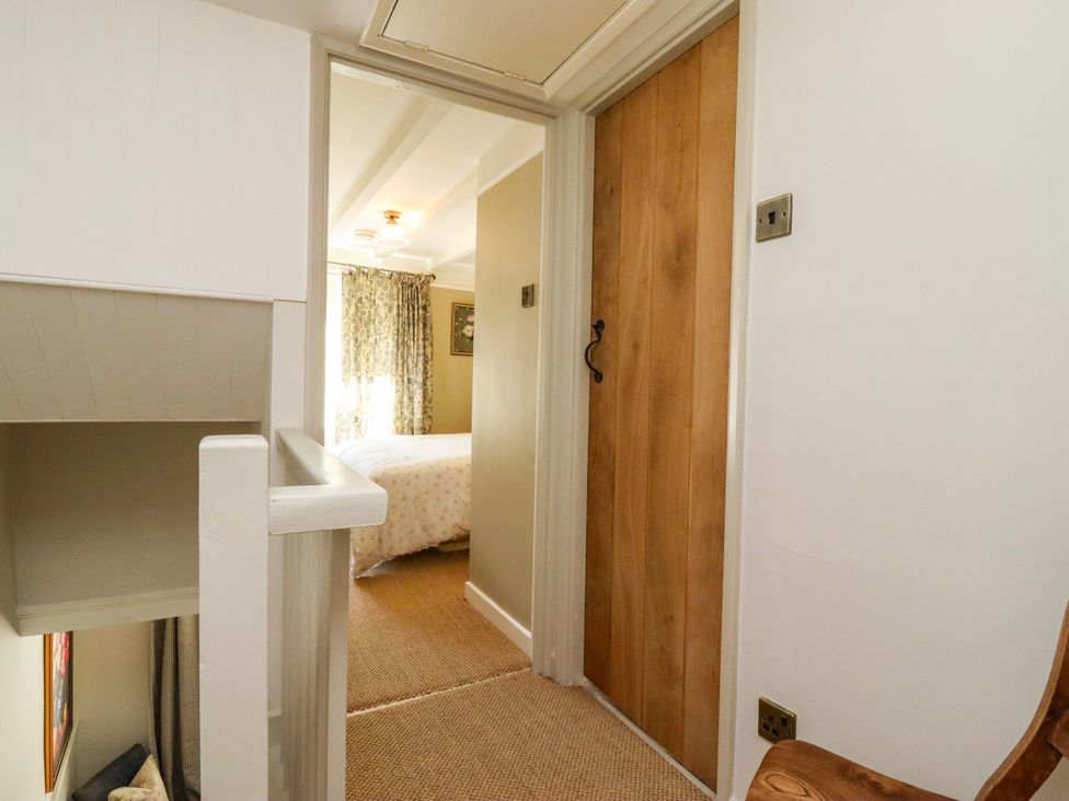 A hallway with a staircase and a door at Blue Cottage in Malton