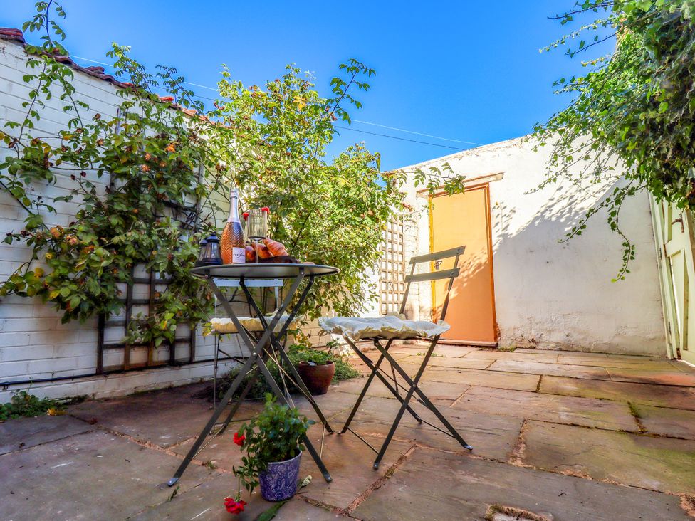 A garden with a table and chairs at Blue Cottage in Malton