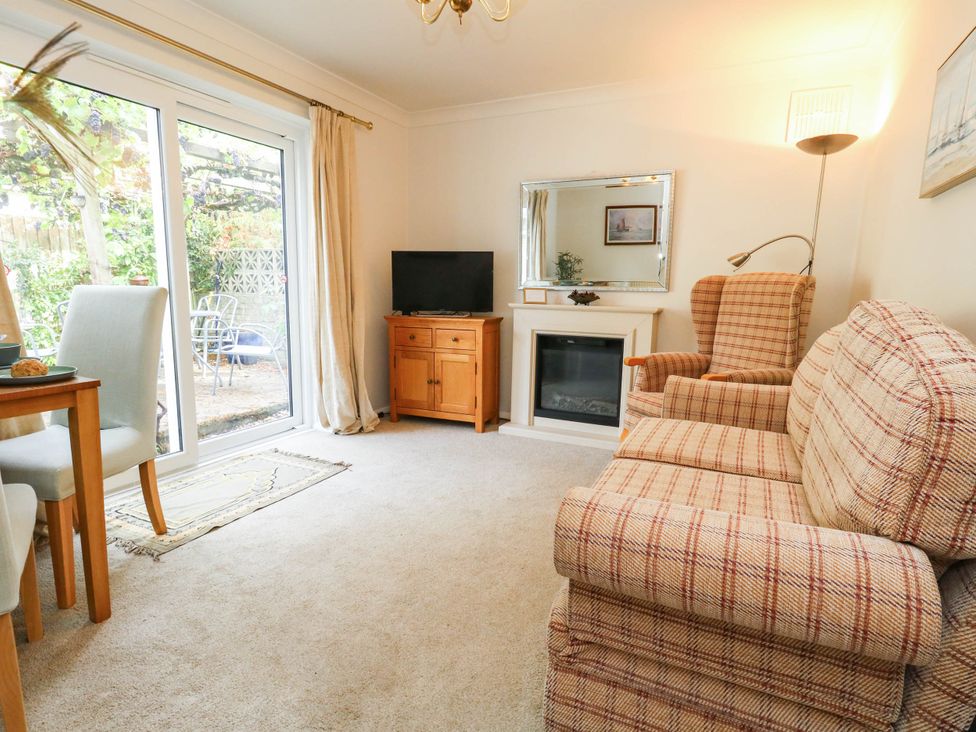 A living room with a sofa and television at Sunnydale near Corfe Mullen