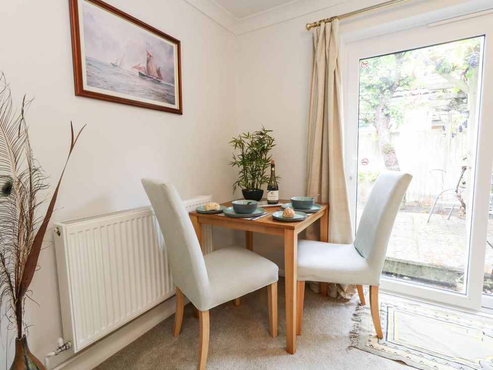 A dining room with a table and chairs at Sunnydale near Corfe Mullen