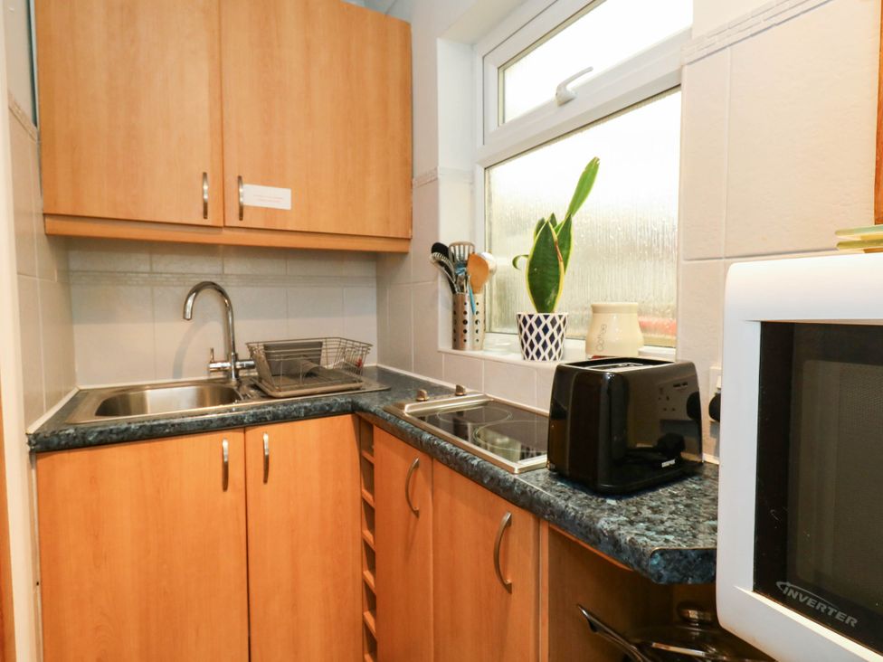 A kitchen with a sink, countertops, and appliances at Sunnydale near Corfe Mullen