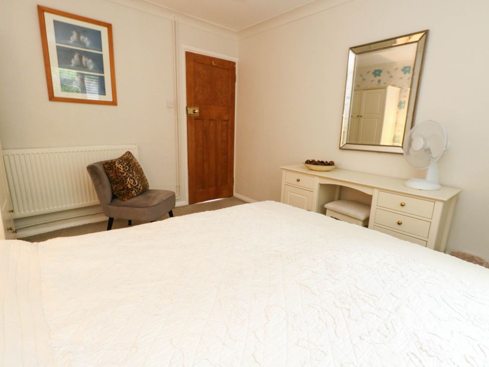 A bedroom with furniture including a bed and desk at Sunnydale near Corfe Mullen