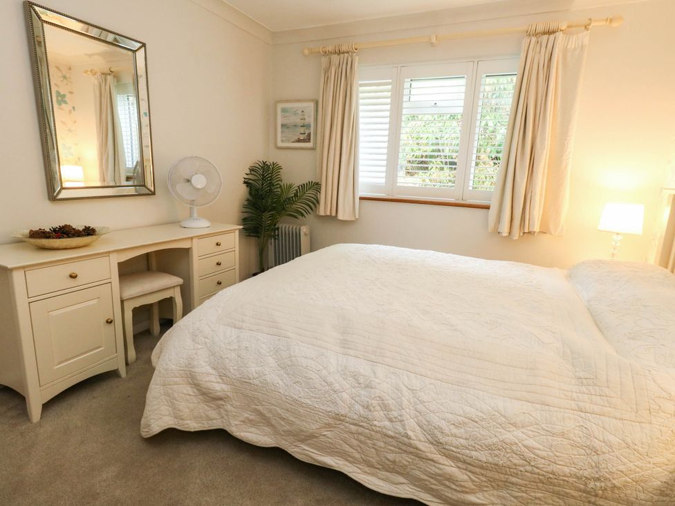 A bedroom with a bed and a desk at Sunnydale near Corfe Mullen