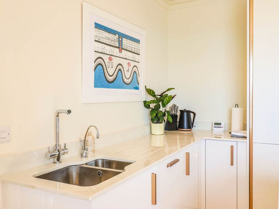 A kitchen with a sink, kettle, and plant at 30 Southdown Avenue Weymouth