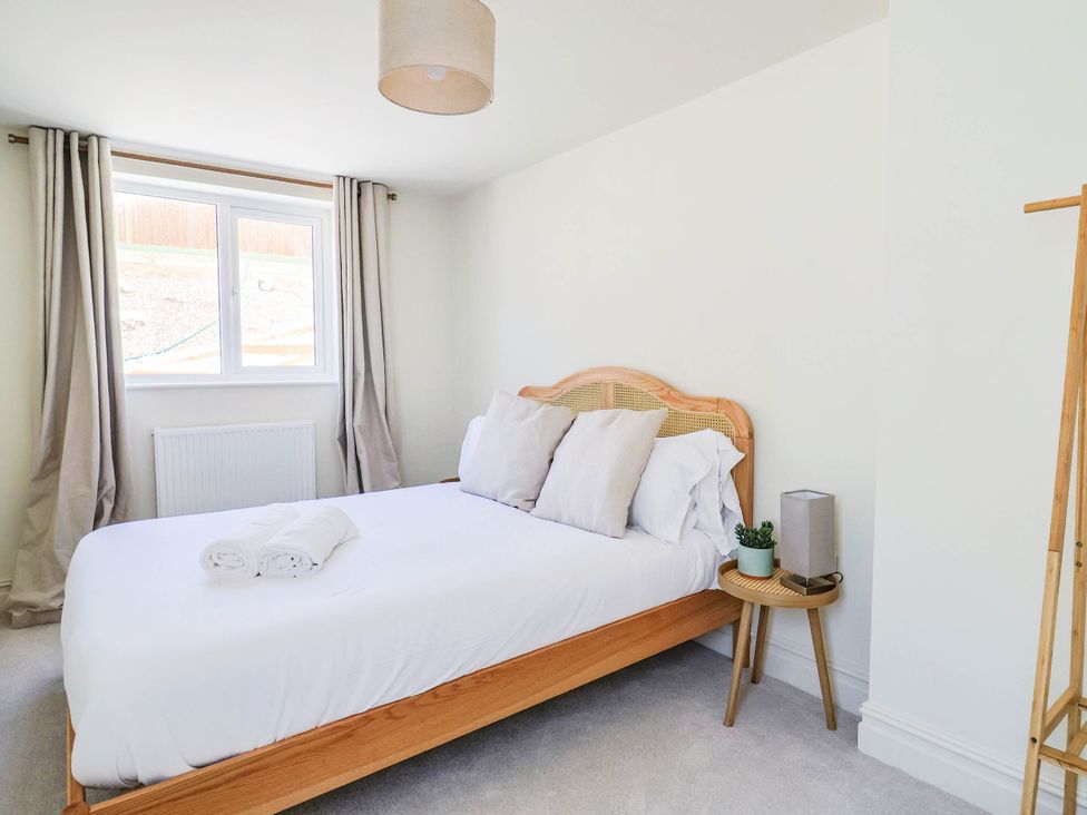 A bedroom with a bed and pillows at 30 Southdown Avenue in Weymouth