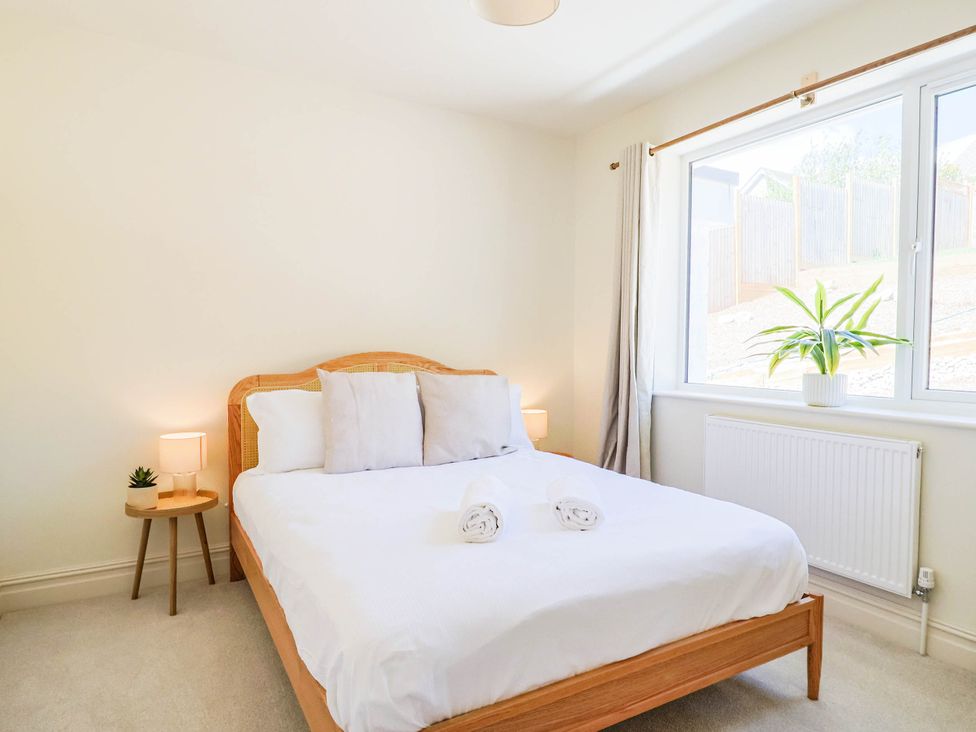 A bedroom with a bed and plant at 30 Southdown Avenue in Weymouth
