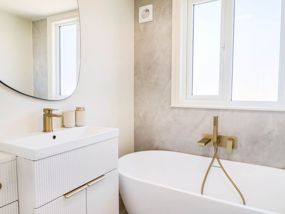 A bathroom with a sink and a bathtub at 30 Southdown Avenue in Weymouth