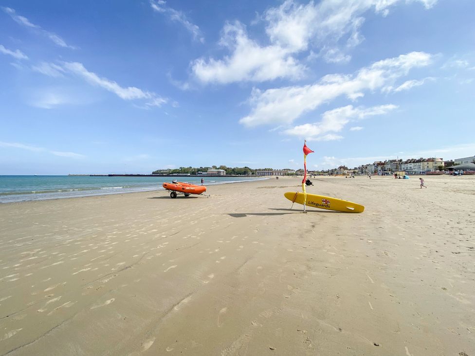 A beach with lifeguard boat and surfboard at 30 Southdown Avenue Weymouth