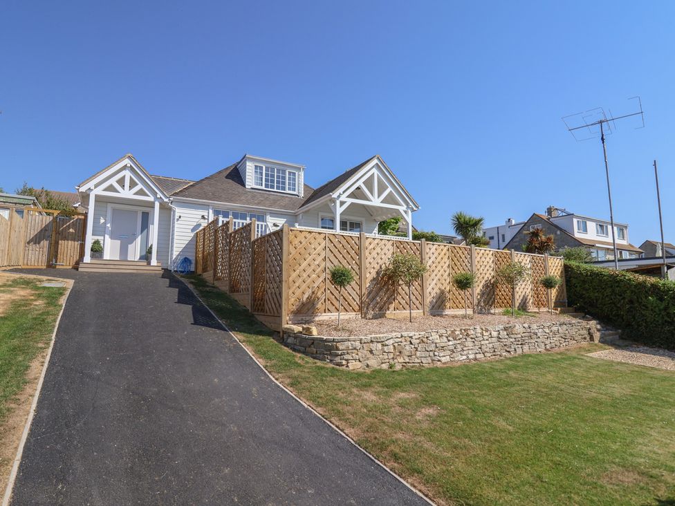 A house with a wooden fence and pathway at 30 Southdown Avenue Weymouth