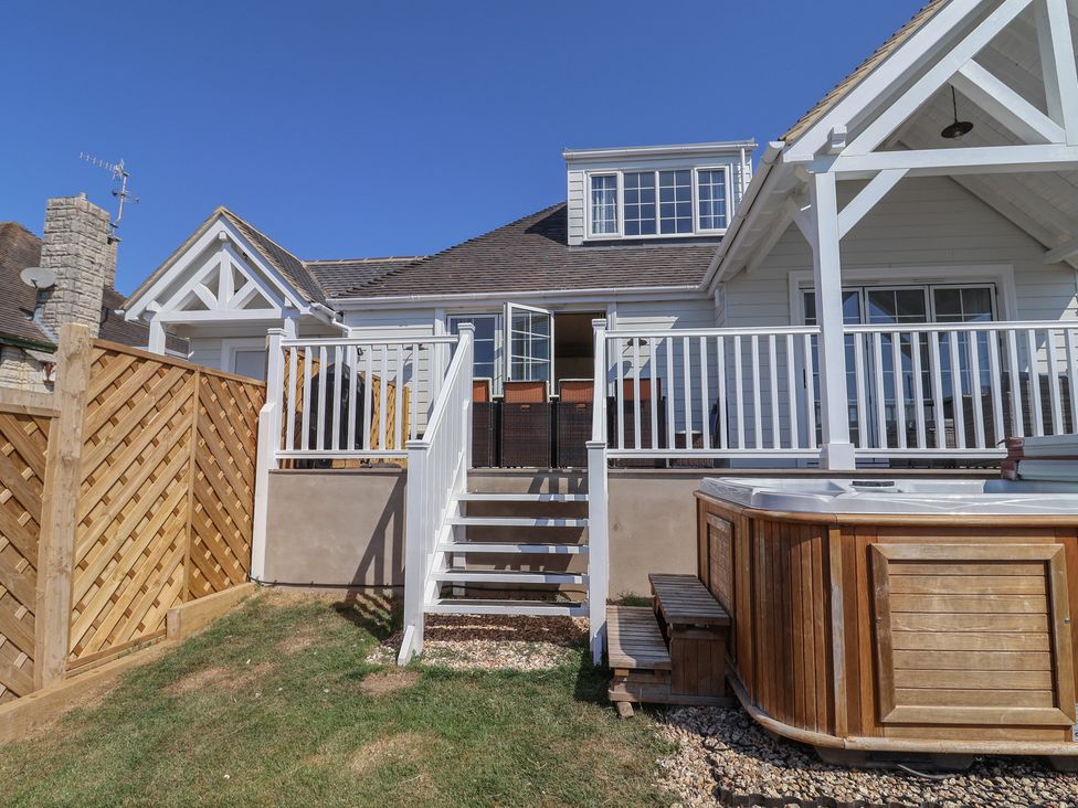 An outdoor area with a hot tub and stairs at 30 Southdown Avenue Weymouth