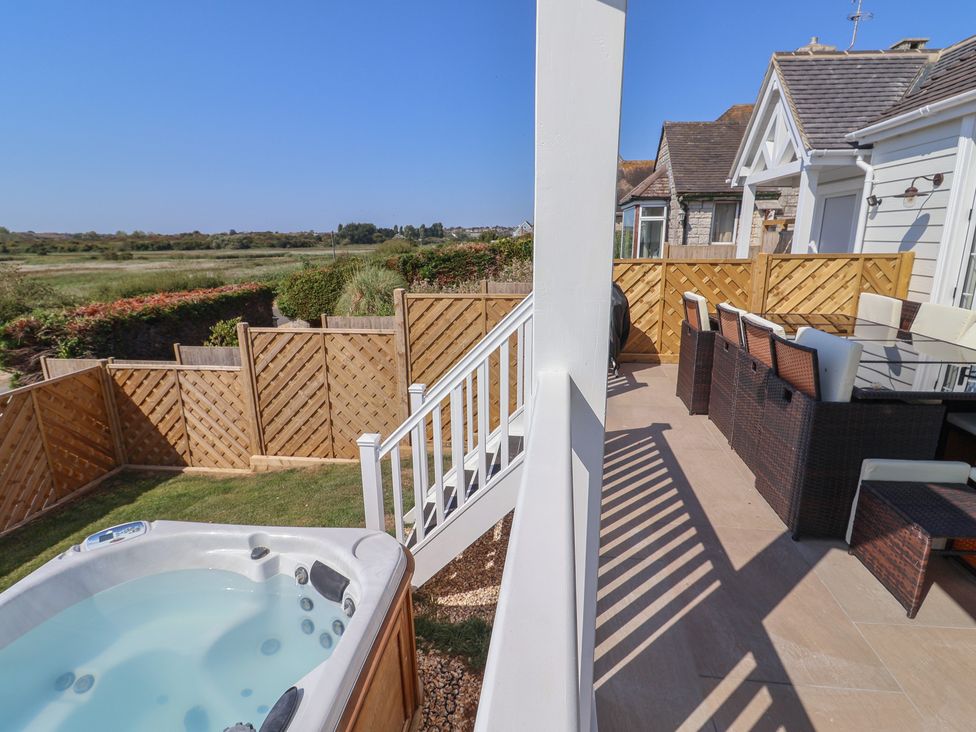 An outdoor area with a hot tub and furniture at 30 Southdown Avenue, Weymouth