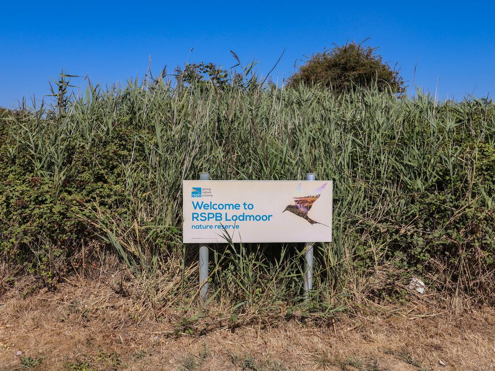 A sign for RSPB Lodmoor nature reserve in an outdoor area