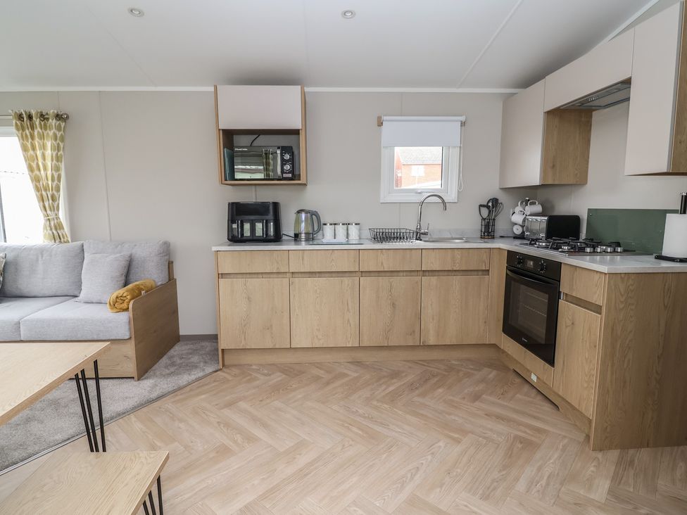 A kitchen with cabinets and appliances at S7 in Abergele
