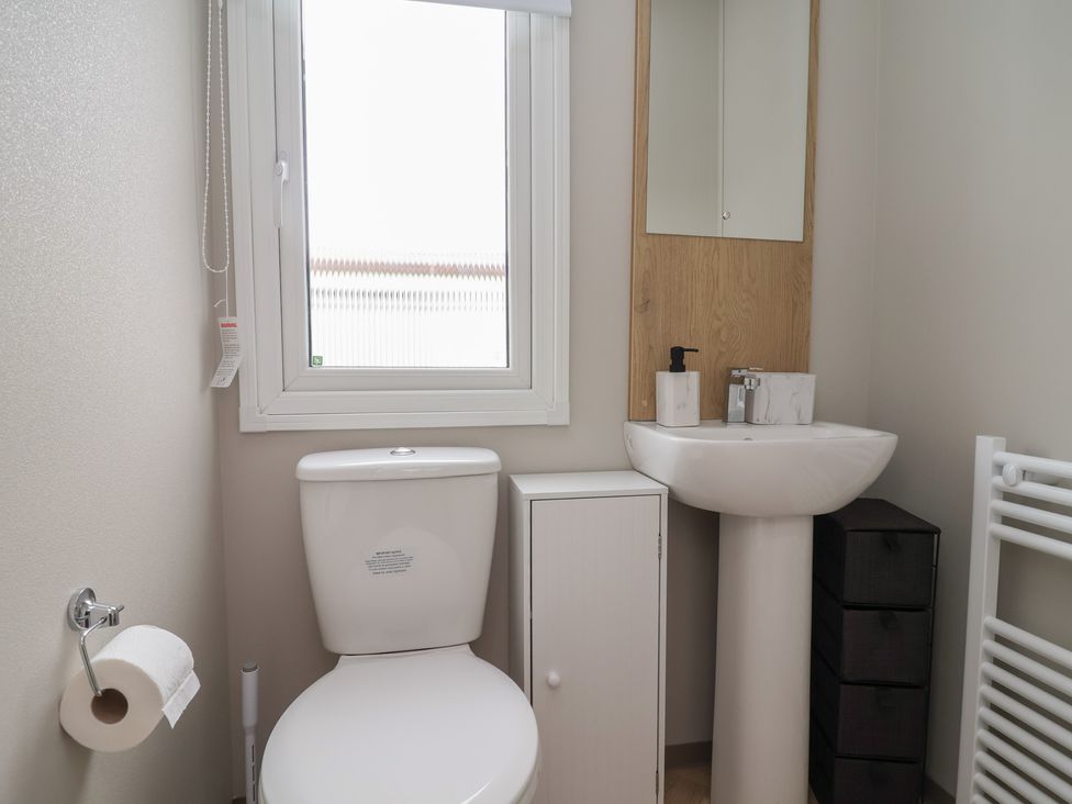A bathroom with a toilet and sink at S7 in Abergele
