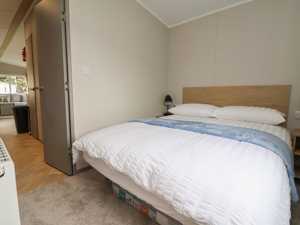 A bedroom with a bed and nightstand at S7 in Abergele