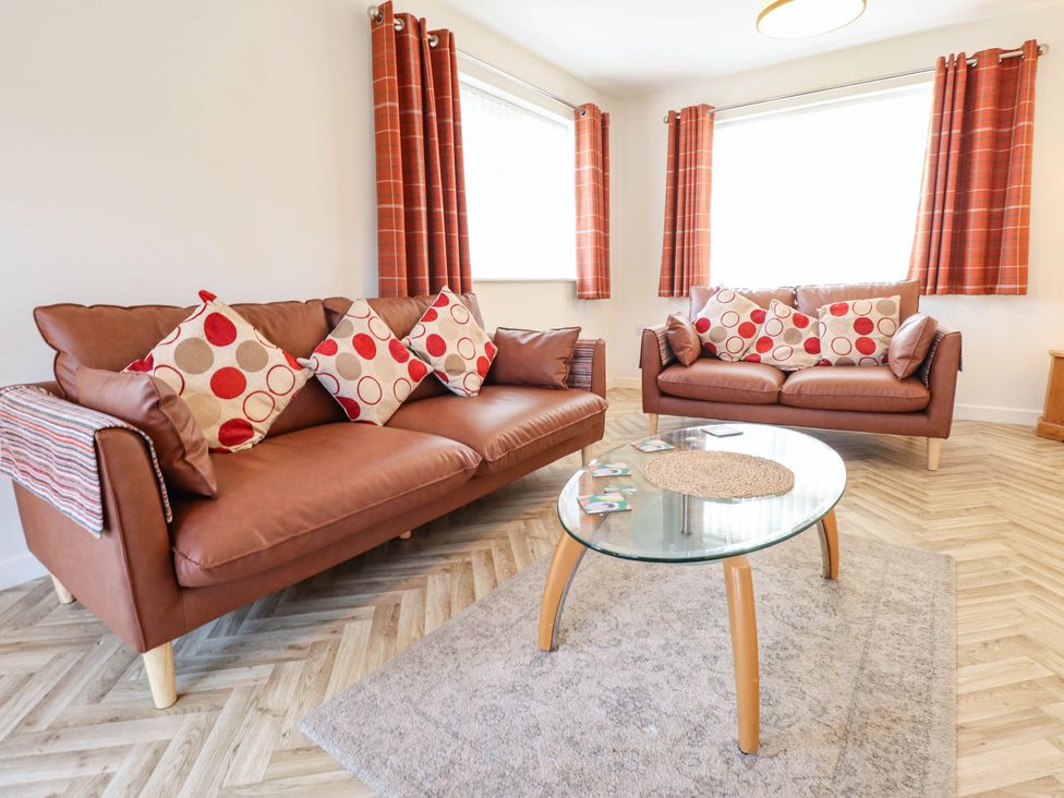 A living room with two sofas and a coffee table at Beach Lodge