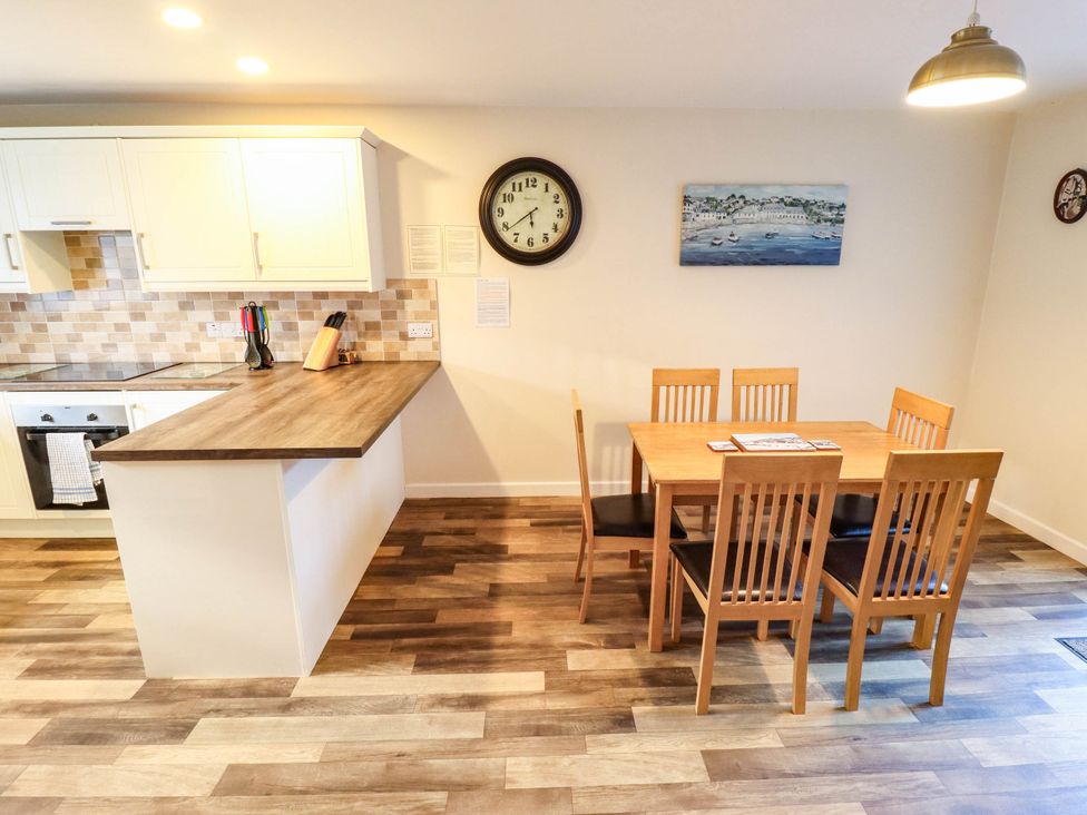 A kitchen with a dining table and chairs at Beach Lodge