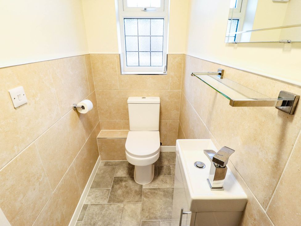 A bathroom with a toilet and sink at Beach Lodge