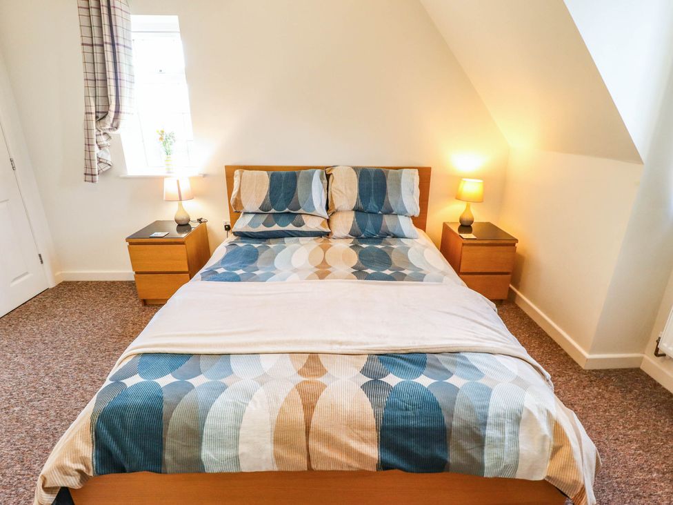 A bedroom with a bed and nightstands at Beach Lodge