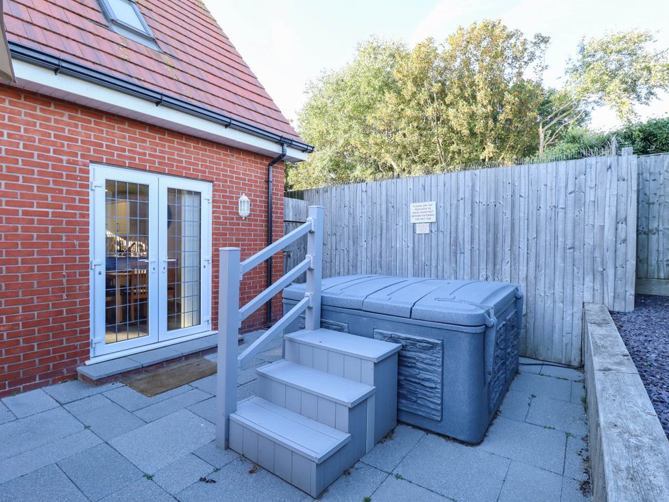 An outdoor area with a hot tub and steps at Beach Lodge