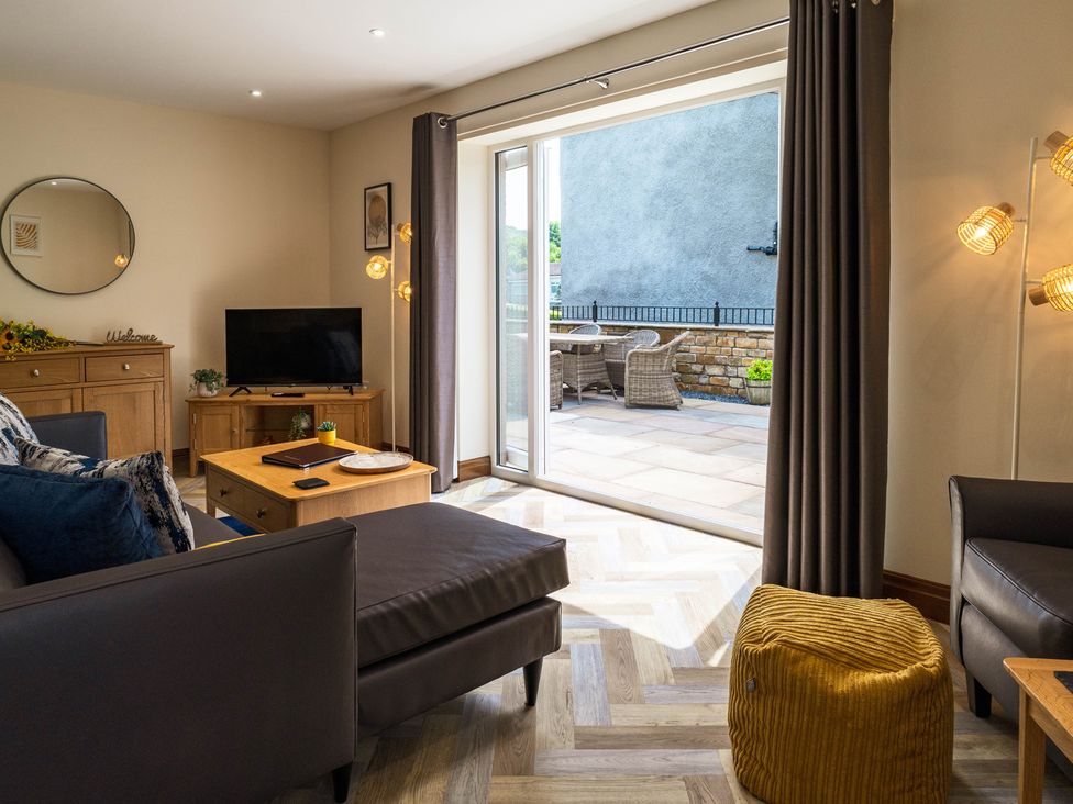 A living room with a television and coffee table at Bay Bungalow 