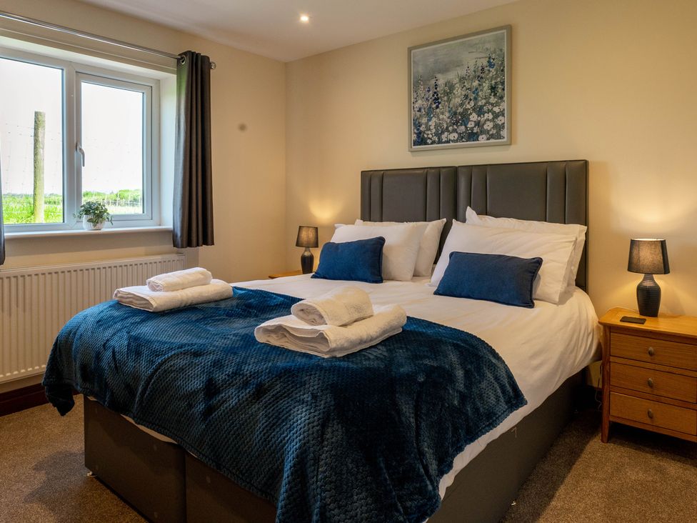A bedroom with a bed and window at Bay Bungalow