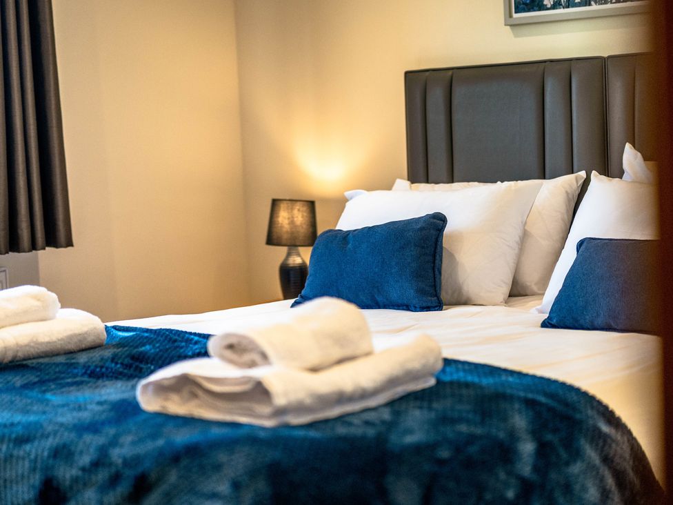 A bedroom with a bed and pillows at Bay Bungalow