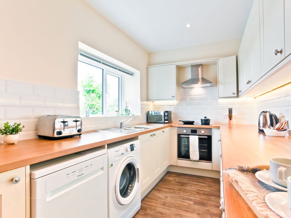 A kitchen with a sink and appliances at Hillberry Cottage in Carnforth