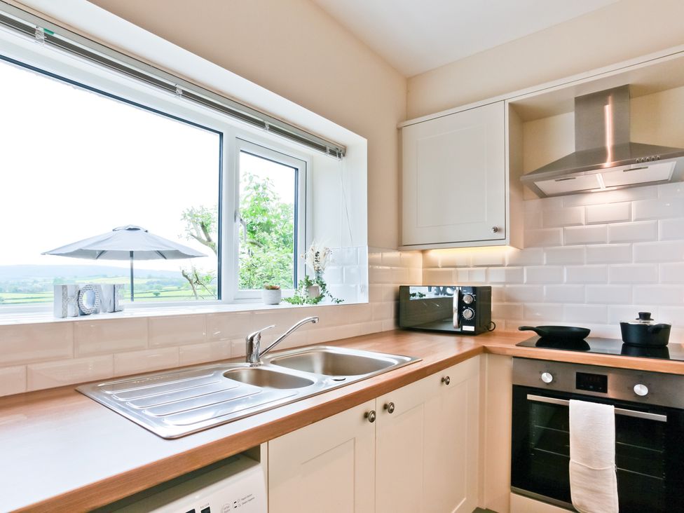 A kitchen with a sink and countertop at Hillberry Cottage in Carnforth