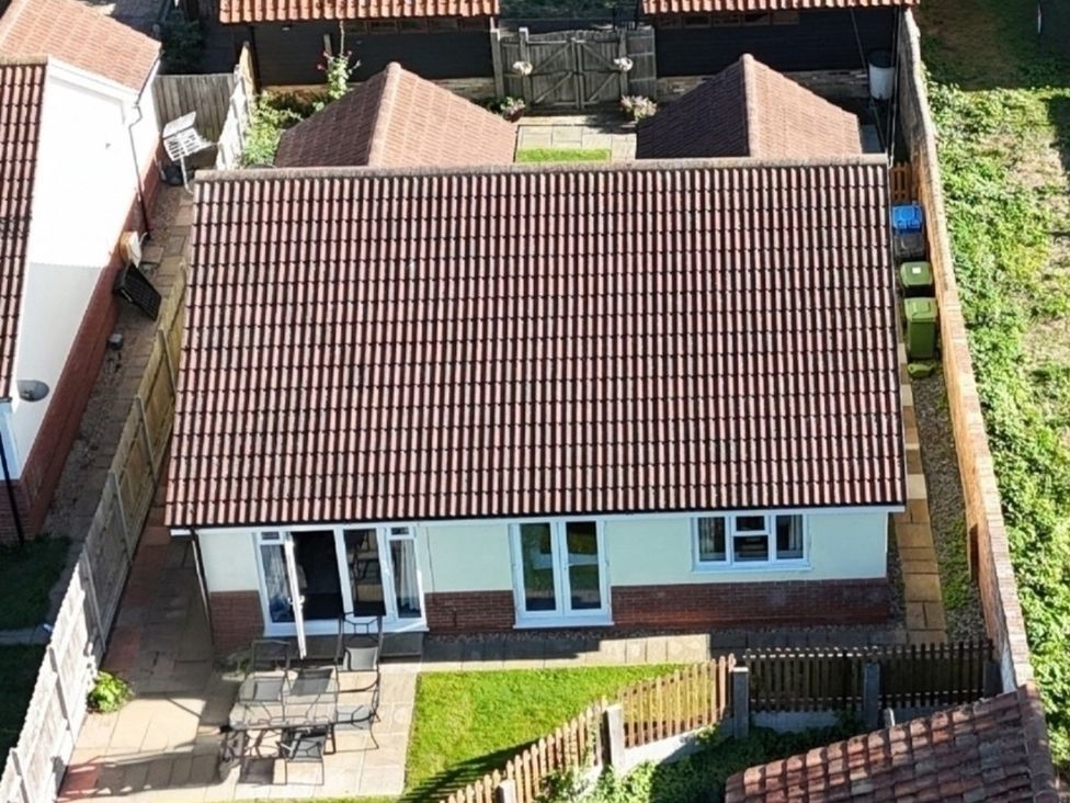 A house with a patio and garden at The Mill House Apartment in Oulton Broad