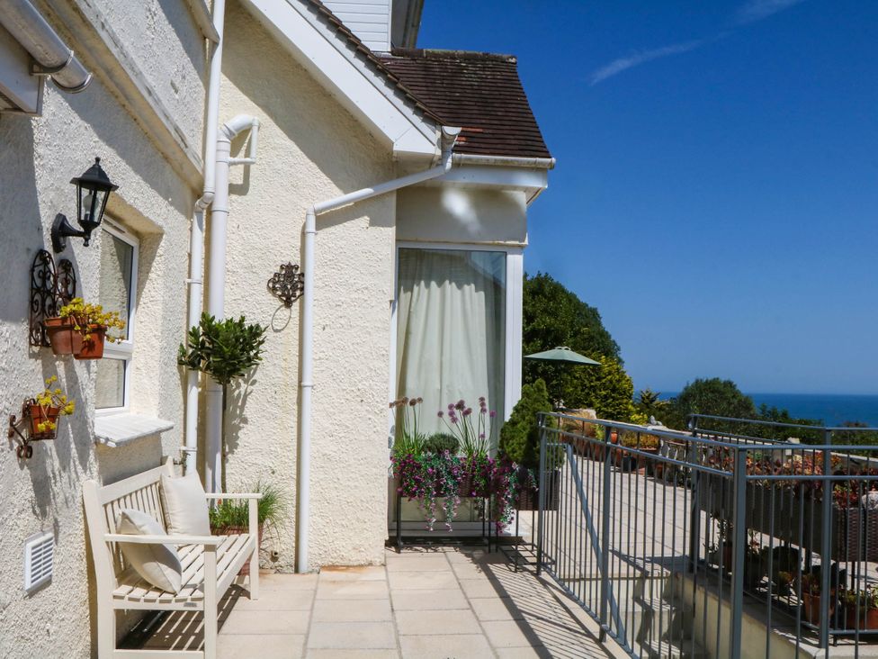 An outdoor area with a bench and planters at Elberry Cove View in Paignton