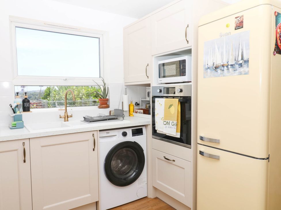 A kitchen with appliances and a sink at Elberry Cove View in Paignton