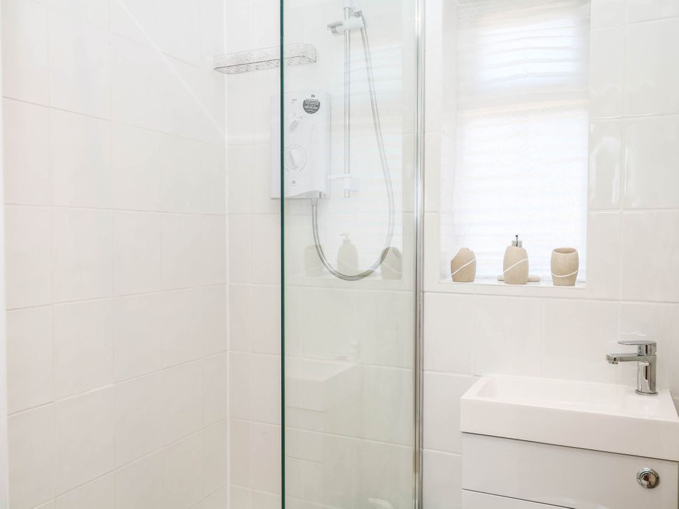 A bathroom with a shower and sink at Elberry Cove View in Paignton