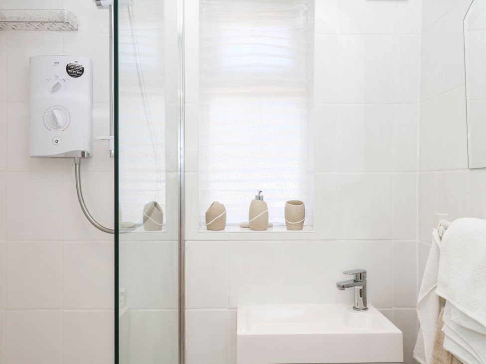 A bathroom with a shower and sink at Elberry Cove View in Paignton
