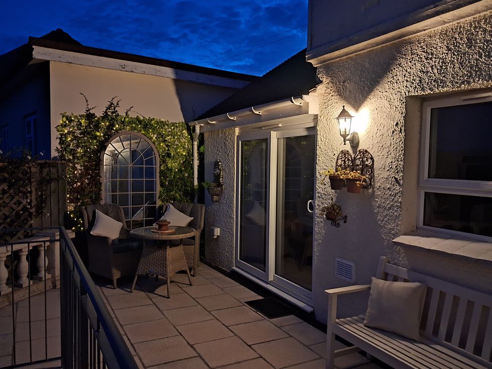 A patio with table and chairs at Elberry Cove View in Paignton