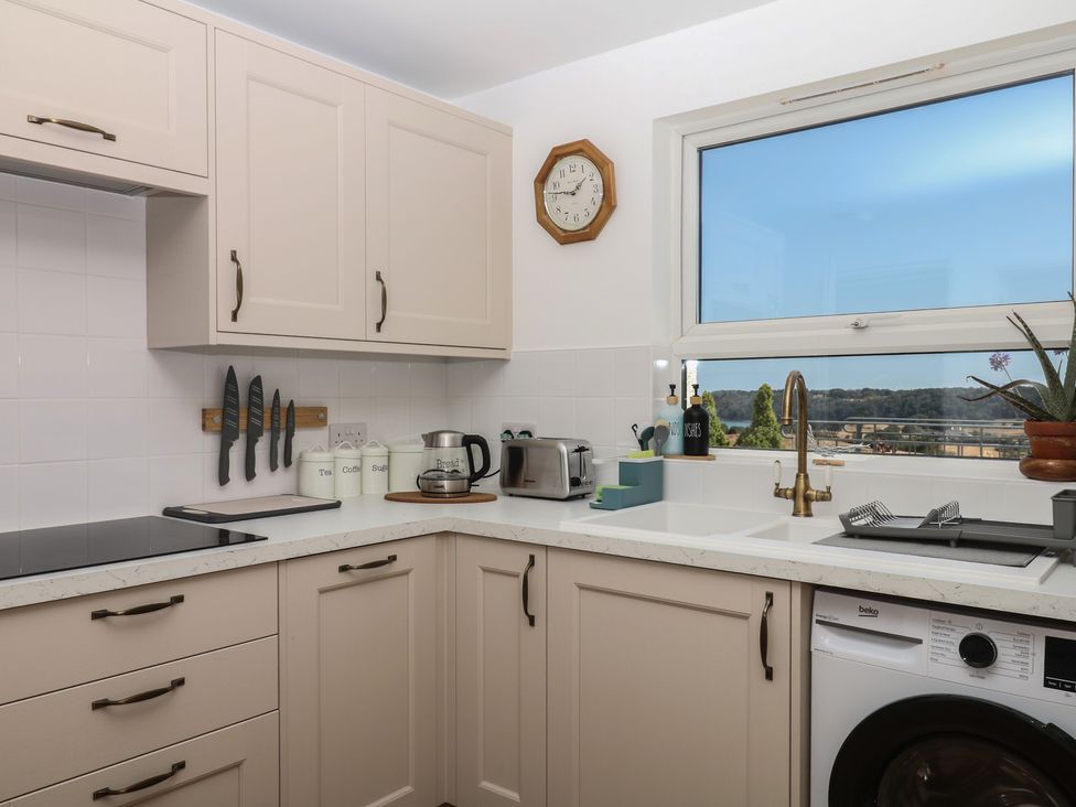 A kitchen with cabinets, sink and appliances at Elberry Cove View in Paignton