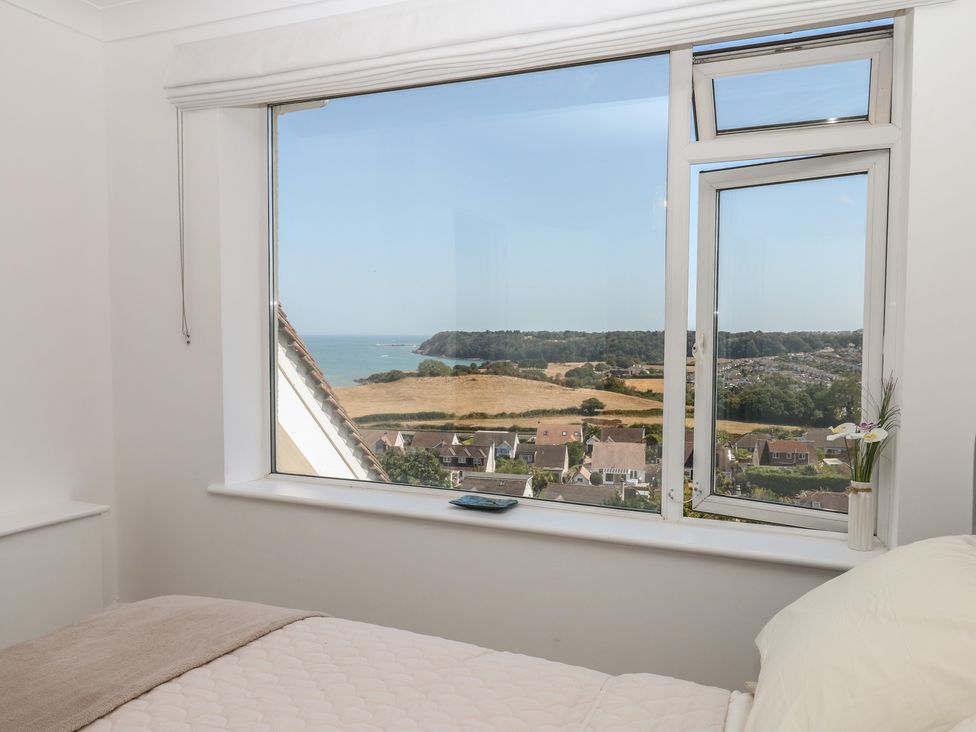 A bedroom with a sea view at Elberry Cove View in Paignton