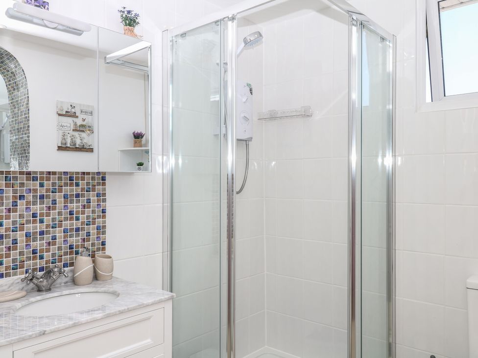A bathroom with a shower and sink at Elberry Cove View in Paignton