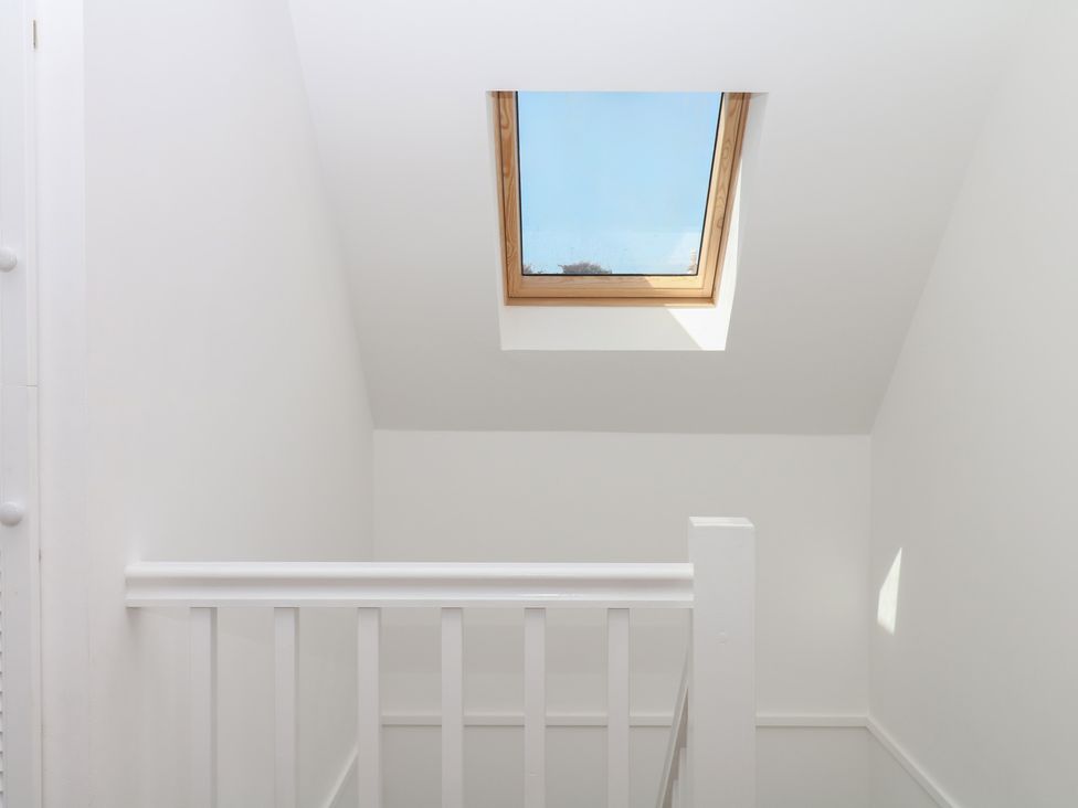 A staircase with a skylight at Elberry Cove View in Paignton