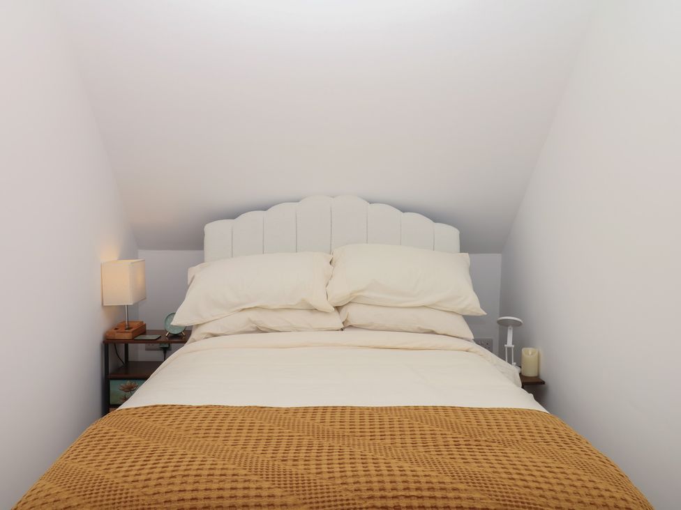 A bedroom with a bed and bedside lamp at Elberry Cove View in Paignton
