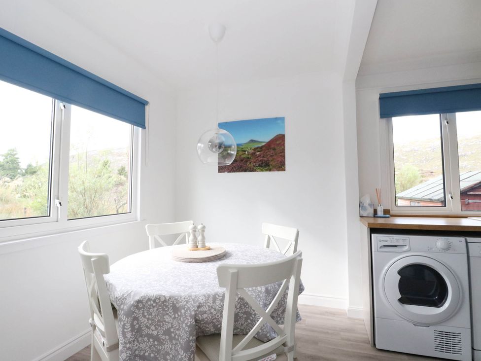 A dining room with a table and chairs at Skye View Isle of Harris