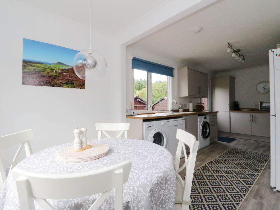 A kitchen with a dining table and chairs at Skye View in Isle of Harris