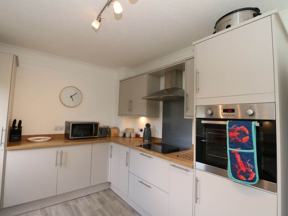 A kitchen with countertop appliances and storage at Skye View in Isle of Harris