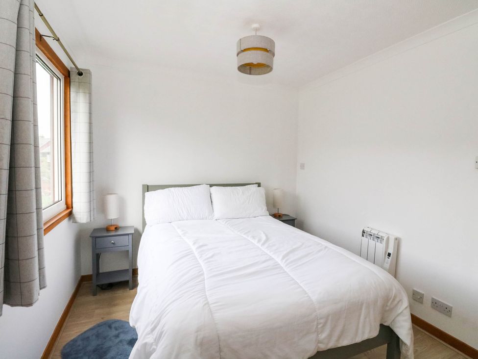 A bedroom with a bed and nightstand at Skye View Isle of Harris