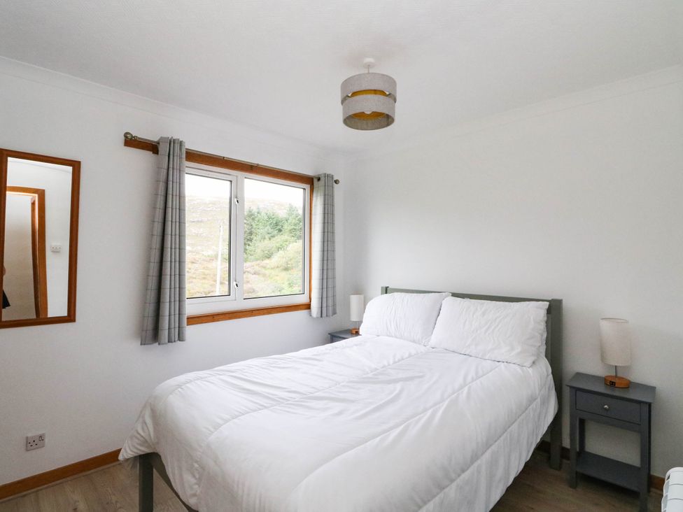 A bedroom with a bed and nightstands at Skye View in Isle of Harris