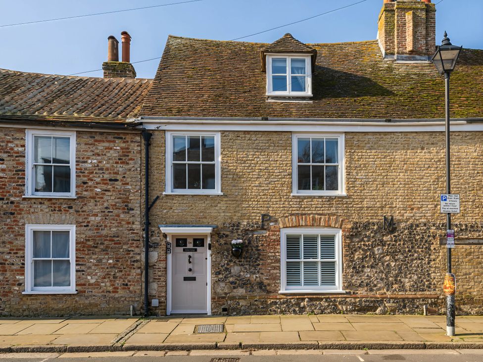 An exterior view of a house with brick and stone facade at CobNut Cottage in Sandwich