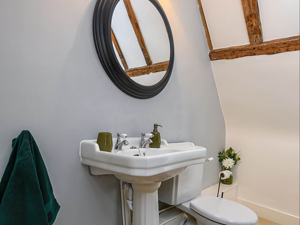 A bathroom with a sink and toilet at CobNut Cottage in Sandwich