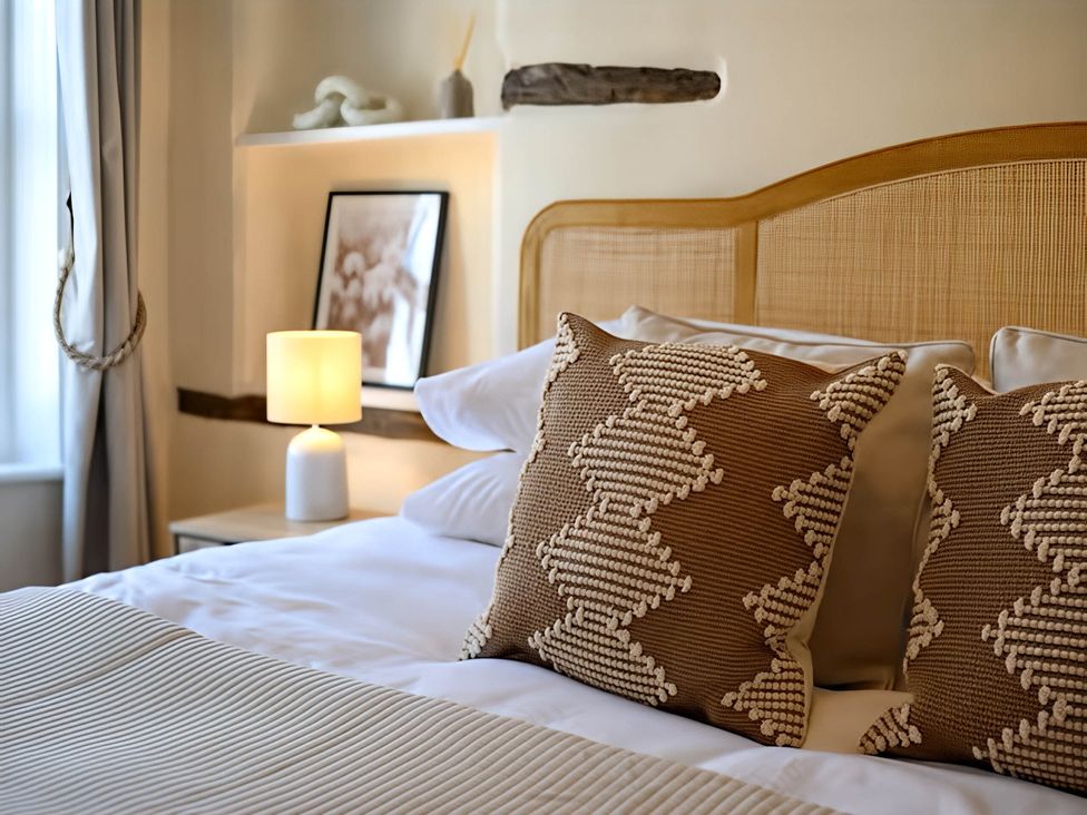 A bedroom with a bed and pillows at CobNut Cottage Sandwich